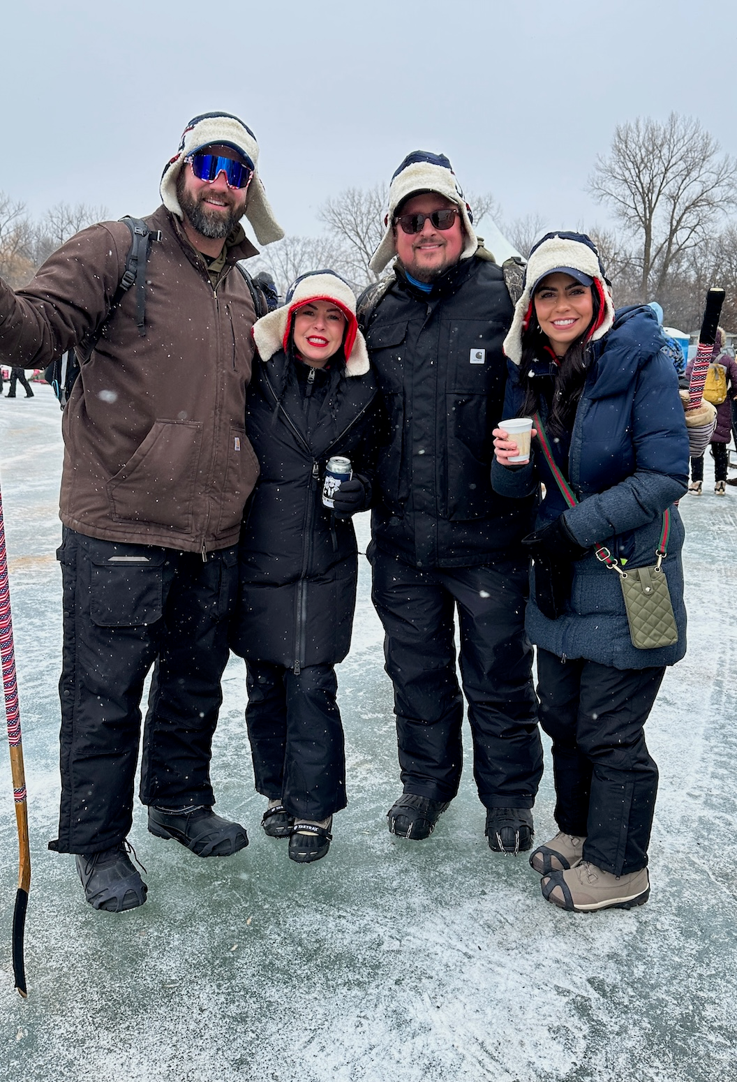 4 golfers posing with hockey stick.